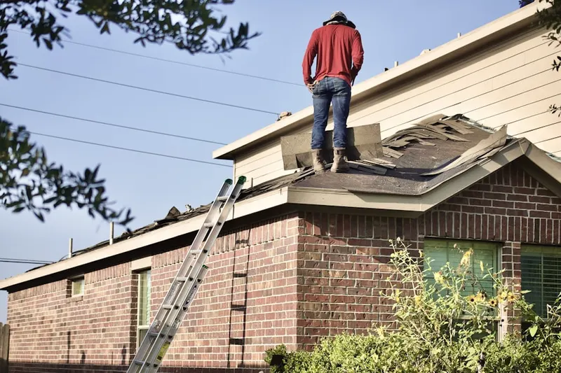 Professional roofer working on a residential roof in Indian Spring